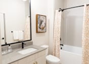 Thumbnail 7 of 53 - Radiant bathroom with bright mirror light at District on the Etowah Apartments, Georgia