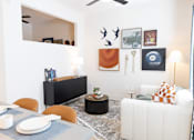 Thumbnail 3 of 53 - Table, painting on wall and couch at District on the Etowah Apartments, Canton, 30114