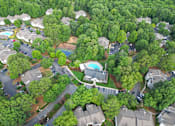 Thumbnail 35 of 40 - A bird's eye view of a residential area with houses, trees, and a swimming pool.