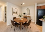 Thumbnail 23 of 40 - A dining room with a round table and chairs.
