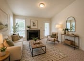 Thumbnail 19 of 40 - A cozy living room with a fireplace and comfortable seating.