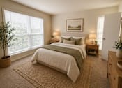 Thumbnail 22 of 40 - A bedroom with a large bed and a painting on the wall.