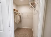 Thumbnail 10 of 40 - A white closet with a white door and a white shelf.