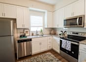 Thumbnail 1 of 33 - Apartment home kitchen with white shaker cabinets located in Naples,FL