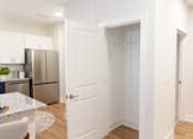 Thumbnail 2 of 43 - Kitchen with white cabinets and a refrigerator at The Crest at Oakwood, Oakwood