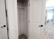Thumbnail 28 of 60 - a walk in closet with white doors and a white closet door open to a bedroom at The Crest at South Point Apartments, Georgia, 30253