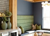 Thumbnail 39 of 66 - A modern kitchen with a green sofa and a wooden counter.at Riverside Apartments, Chattanooga, 37406