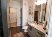 Thumbnail 8 of 46 - The Wren 1 bedroom model apartment home bathroom with granite countertop vanity located in Lawrenceville, GA