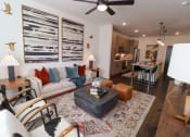 Thumbnail 4 of 46 - The Wren 1 bedroom model apartment home living space with ceiling fan located in Lawrenceville, GA