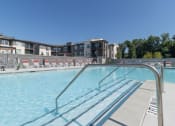 Thumbnail 16 of 46 - The Wren luxury apartment community swimming pool with large pool deck and outdoor seating located in Lawrenceville, GA