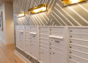 Thumbnail 27 of 46 - the mail room has plenty of cabinets and a bunch of drawers at The Wren Apartments, Lawrenceville, GA, 30043