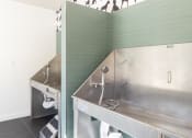 Thumbnail 36 of 46 - a stainless steel kitchen with two stainless steel sinks and a large stainless steel counter top at The Wren Apartments, Georgia, 30043