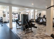 Thumbnail 28 of 46 - a gym with cardio equipment and weights in a home gym at The Wren Apartments, Georgia, 30043