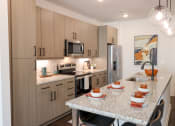 Thumbnail 14 of 46 - The Wren 1 bedroom model apartment home kitchen with stainless steel appliances located in Lawrenceville,GA