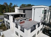 Thumbnail 25 of 46 - an aerial view of a roof terrace at a building with a patio at The Wren Apartments, Lawrenceville, GA, 30043