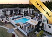 Thumbnail 1 of 46 - A swimming pool is surrounded by a patio and a building.