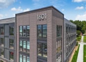 Thumbnail 4 of 18 - the side of a brick building with the number 1001 on it