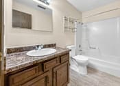 Thumbnail 13 of 13 - A bathroom with a sink, toilet, and bathtub.