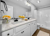 Thumbnail 11 of 12 - A bathroom with a white sink and a white toilet.