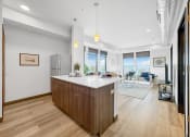 Thumbnail 10 of 18 - a kitchen with a large island and a living room