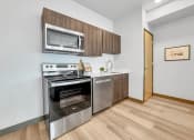 Thumbnail 13 of 18 - a kitchen with stainless steel appliances and a microwave
