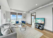 Thumbnail 7 of 18 - a living room with a couch and a tv