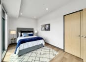 Thumbnail 15 of 18 - a bedroom with a bed and a closet