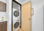 Thumbnail 18 of 18 - a small laundry room with a washer and dryer in a door