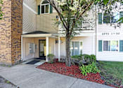 Thumbnail 4 of 11 - APTS 1-30 building with a tree in front.