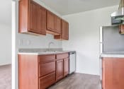 Thumbnail 9 of 14 - a kitchen with wooden cabinets and a stainless steel refrigerator