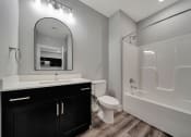 Thumbnail 25 of 48 - a bathroom with a sink toilet and a shower