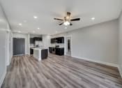 Thumbnail 21 of 48 - an empty living room and kitchen with a ceiling fan