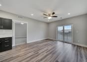Thumbnail 22 of 48 - an empty living room with a ceiling fan and a window
