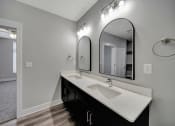 Thumbnail 27 of 48 - a bathroom with a sink and a large mirror