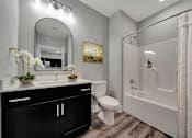 Thumbnail 48 of 48 - A bathroom with a sink, toilet, and bathtub.