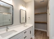 Thumbnail 13 of 32 - A bathroom with a white sink and a mirror above it.