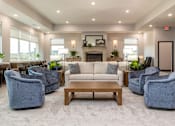 Thumbnail 20 of 32 - A spacious living room with a fireplace and comfortable seating.