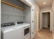 Thumbnail 11 of 32 - A white oven and stove top are in a small kitchen.
