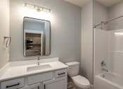 Thumbnail 4 of 32 - A bathroom with a sink, toilet, and bathtub.