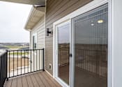 Thumbnail 7 of 32 - A sliding glass door with a screen on the balcony of a house.