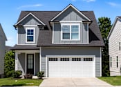 Thumbnail 37 of 44 - A two-story house with a garage door and a window on the second floor.