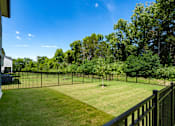 Thumbnail 42 of 44 - A black fence surrounds a green lawn.