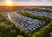 Thumbnail 30 of 44 - A sunset view of a residential area with houses and trees.