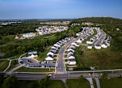 Thumbnail 19 of 44 - A residential area with houses and a road.