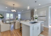 Thumbnail 29 of 32 - A kitchen with a dining table and chairs.