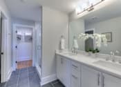 Thumbnail 32 of 32 - A bathroom with two sinks and a large mirror.