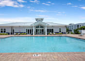 Thumbnail 31 of 47 - A large swimming pool in front of a building.