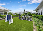 Thumbnail 40 of 47 - A giant chess set is set up on a lawn.