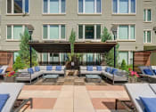 Thumbnail 9 of 15 - an outdoor lounge area with couches and chairs at ALARA Union Station Apartments in Denver, 80202
