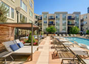 Thumbnail 12 of 15 - Large pool and lounge chairs at ALARA Union Station Apartments in Denver, 80202